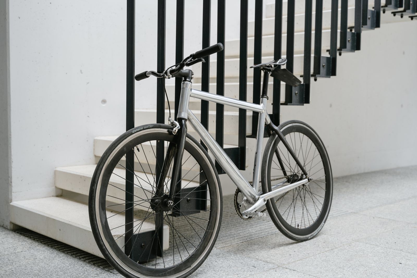 Bicycle leaning against the stair railing in a building entryway
