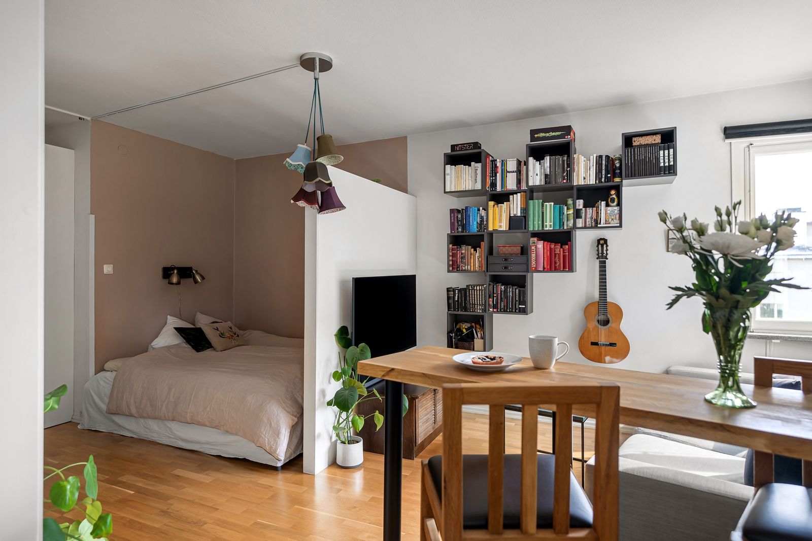 Small bedroom with a bed, a bookshelf, and a wooden desk
